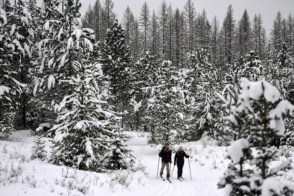 Gabe LePage and Anika Reynar cross-country ski along the Aeneas Loop at the Bigfork Community Nordic Center trails on Foothill Road on Thursday, Jan. 6. (Casey Kreider/Daily Inter Lake)