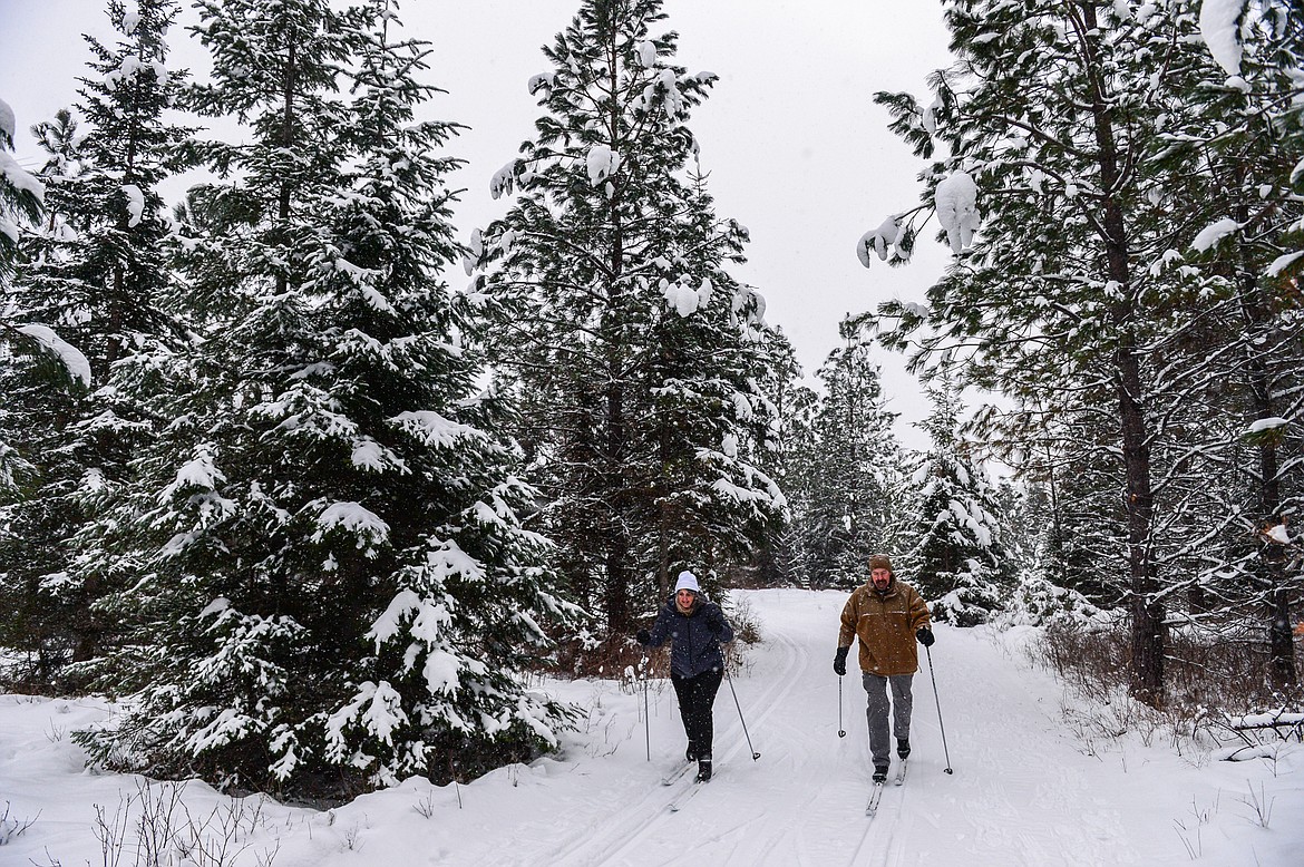 Robert and Melissa Burns cross-country ski along the Aeneas Loop at the Bigfork Community Nordic Center trails on Foothill Road on Wednesday, Jan. 5. (Casey Kreider/Daily Inter Lake)