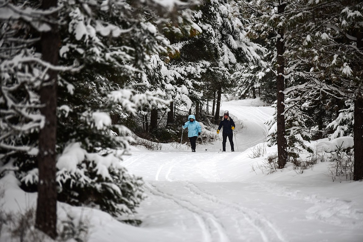 Amy Schmidt and Mattie Willette cross-country ski along the Aeneas Loop at the Bigfork Community Nordic Center trails on Foothill Road on Thursday, Jan. 6. (Casey Kreider/Daily Inter Lake)