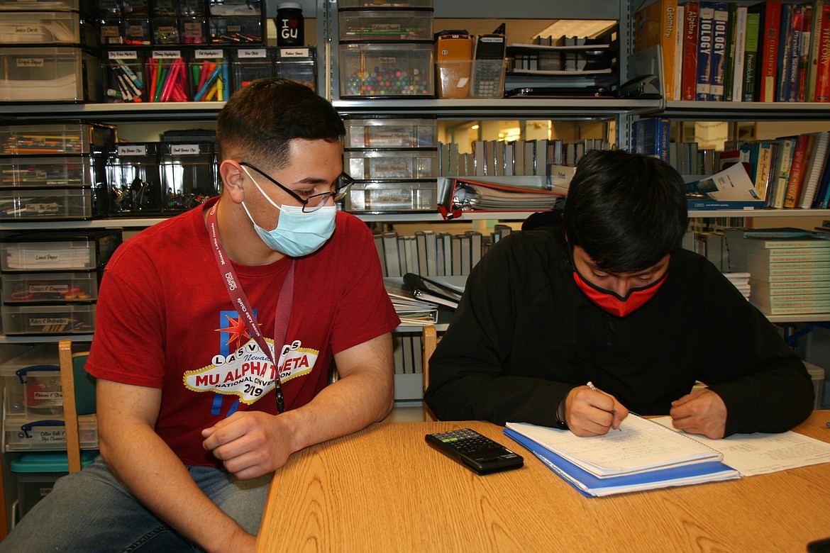 Moses Lake High School senior Samuel Rebuelta, left, works with fellow MLHS student Angel Miguel on Wednesday.