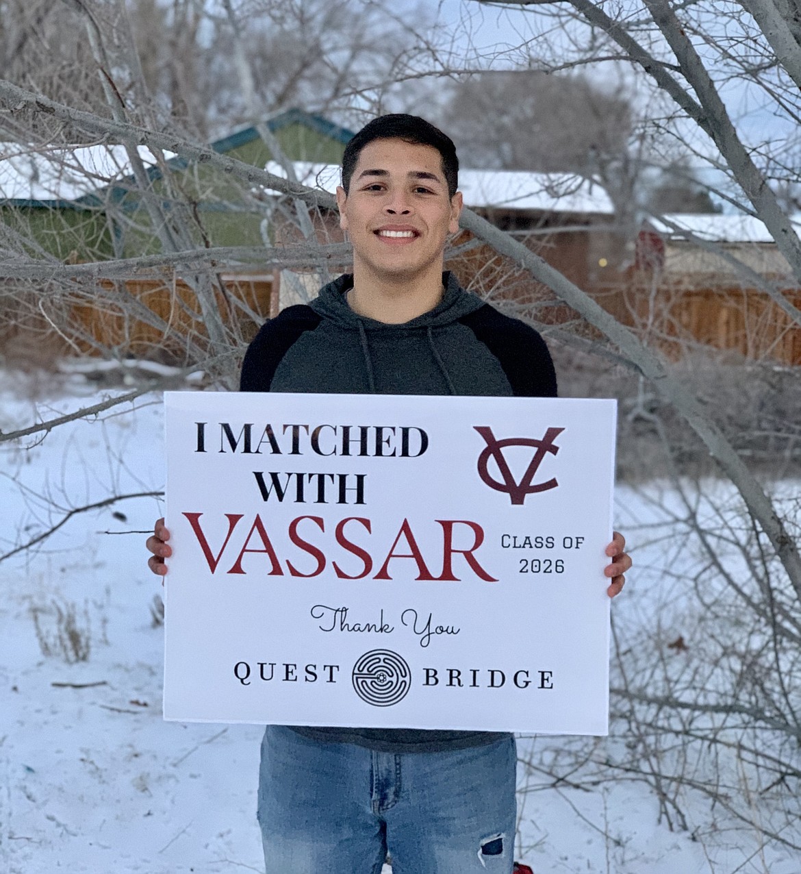 Moses Lake High School senior Samuel Rebuelta holds a sign announcing he “matched with Vassar.”