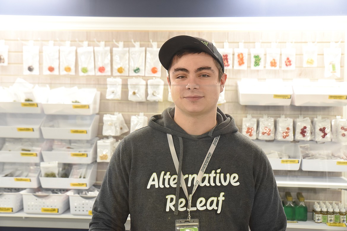 Cody Evans stands in front of the product for sale at Alternative ReLeaf, a dispensary located on U.S. Highway 2 outside of Libby. Barbie Turner, CEO, said sales increased eightfold as recreational marijuana sales opened up Jan. 1. (Derrick Perkins/The Western News)