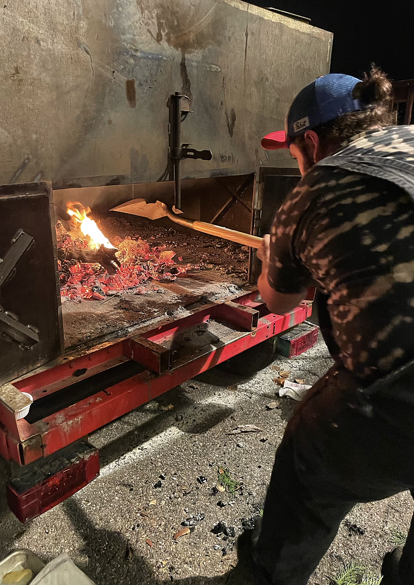 Chef Joshua Lozano leans into the barbecue that was custom made for Defiant BBQ. Large enough to roast a whole pig, it has the capacity to cater for events up to 400 people.