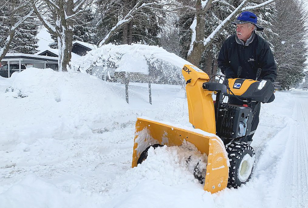 Wes Just uses a snowblower in front of his Hayden home on Thursday.