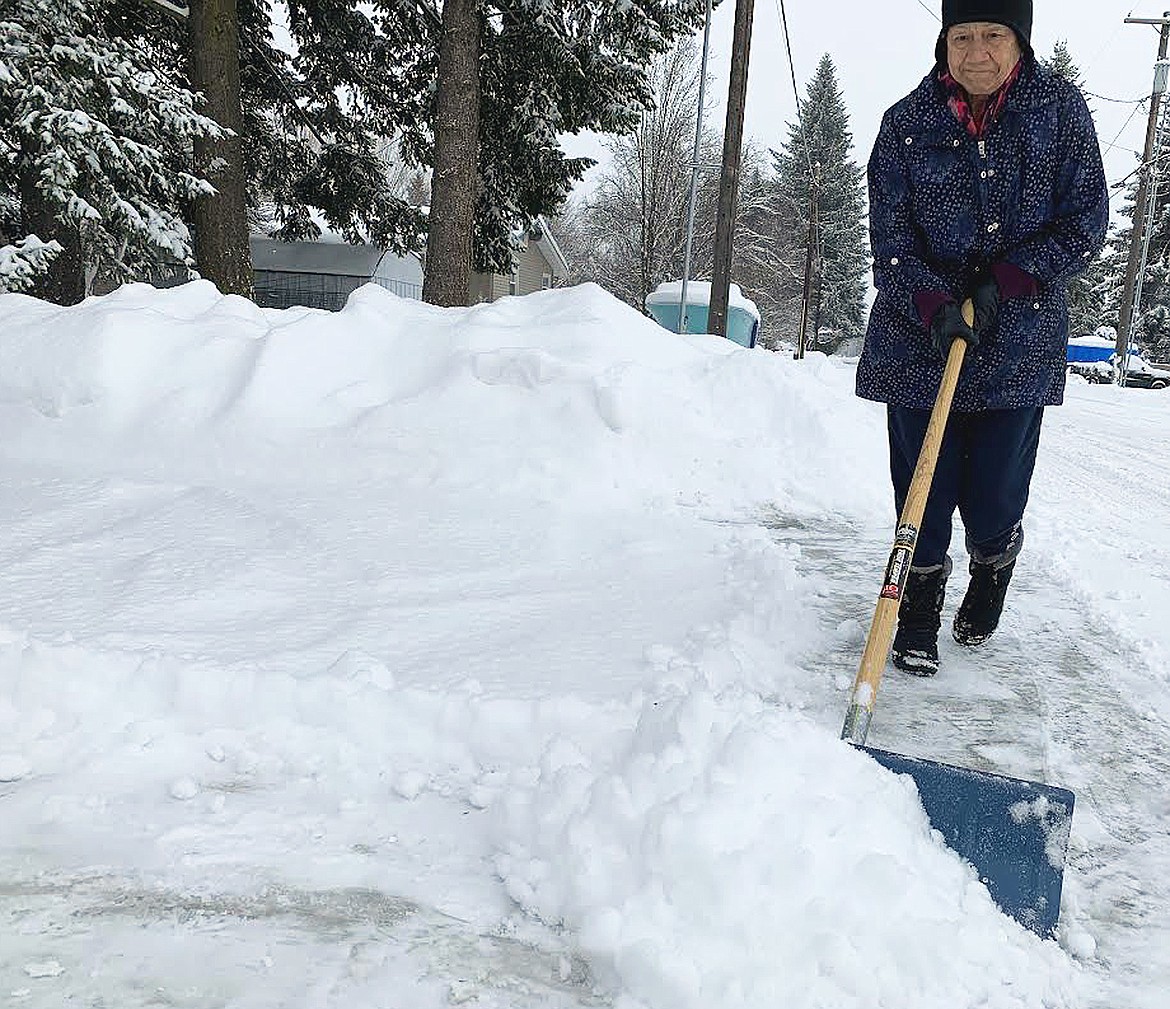 Julie Bishop shovels snow from her Hayden driveway Thursday.