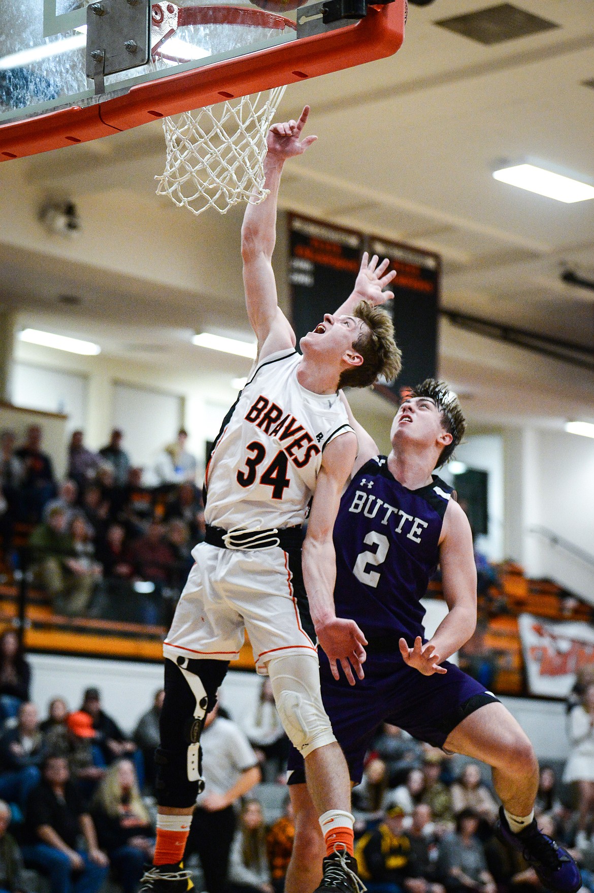 Flathead's Joston Cripe (34) goes to the basket in front of Butte's Jace Stenson (2) at Flathead High School on Friday, Jan. 7. (Casey Kreider/Daily Inter Lake)