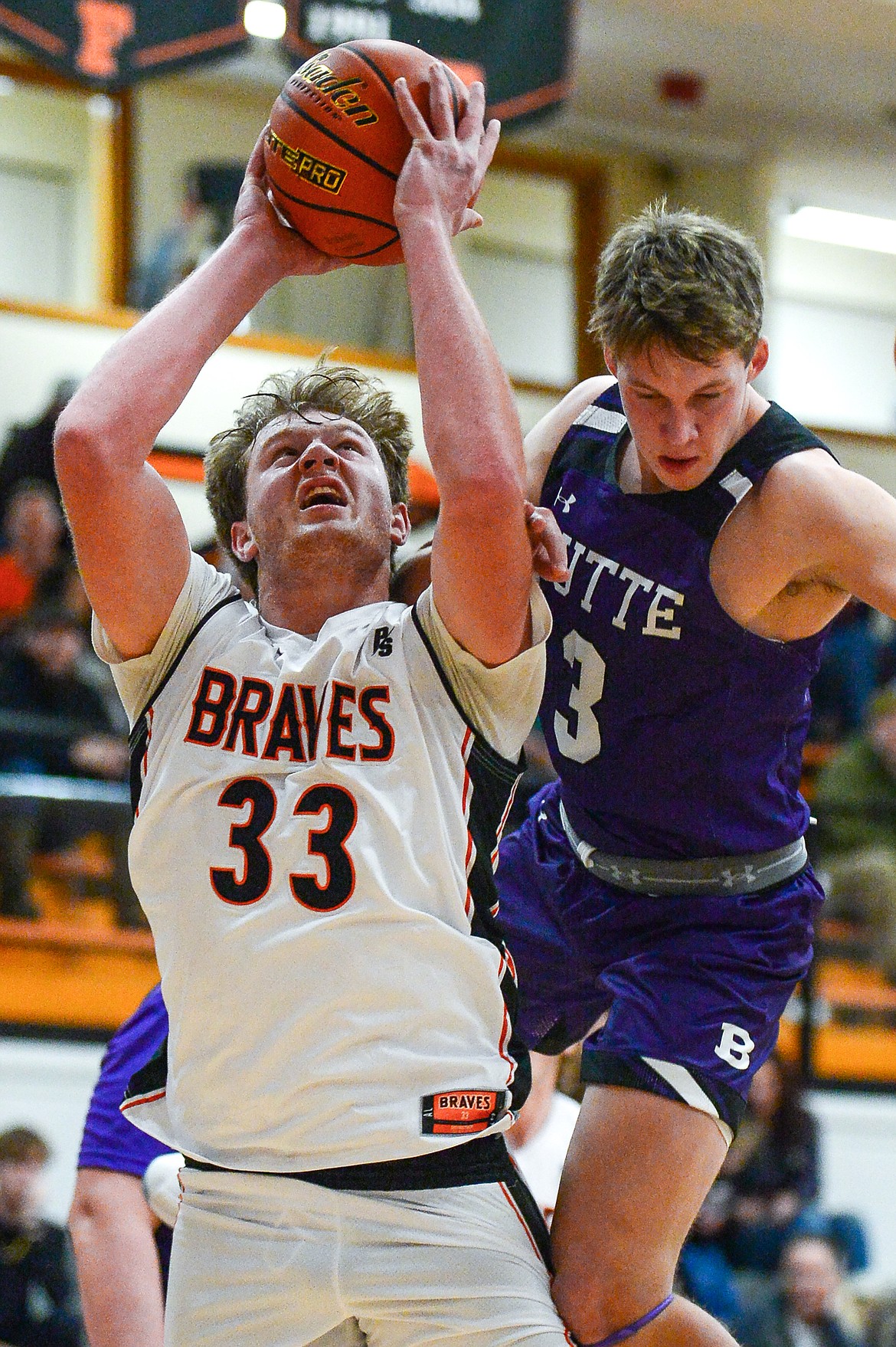 Flathead's Joe Hansen (33) is fouled under the basket by Butte's Cameron Gurnsey (3) at Flathead High School on Friday, Jan. 7. (Casey Kreider/Daily Inter Lake)