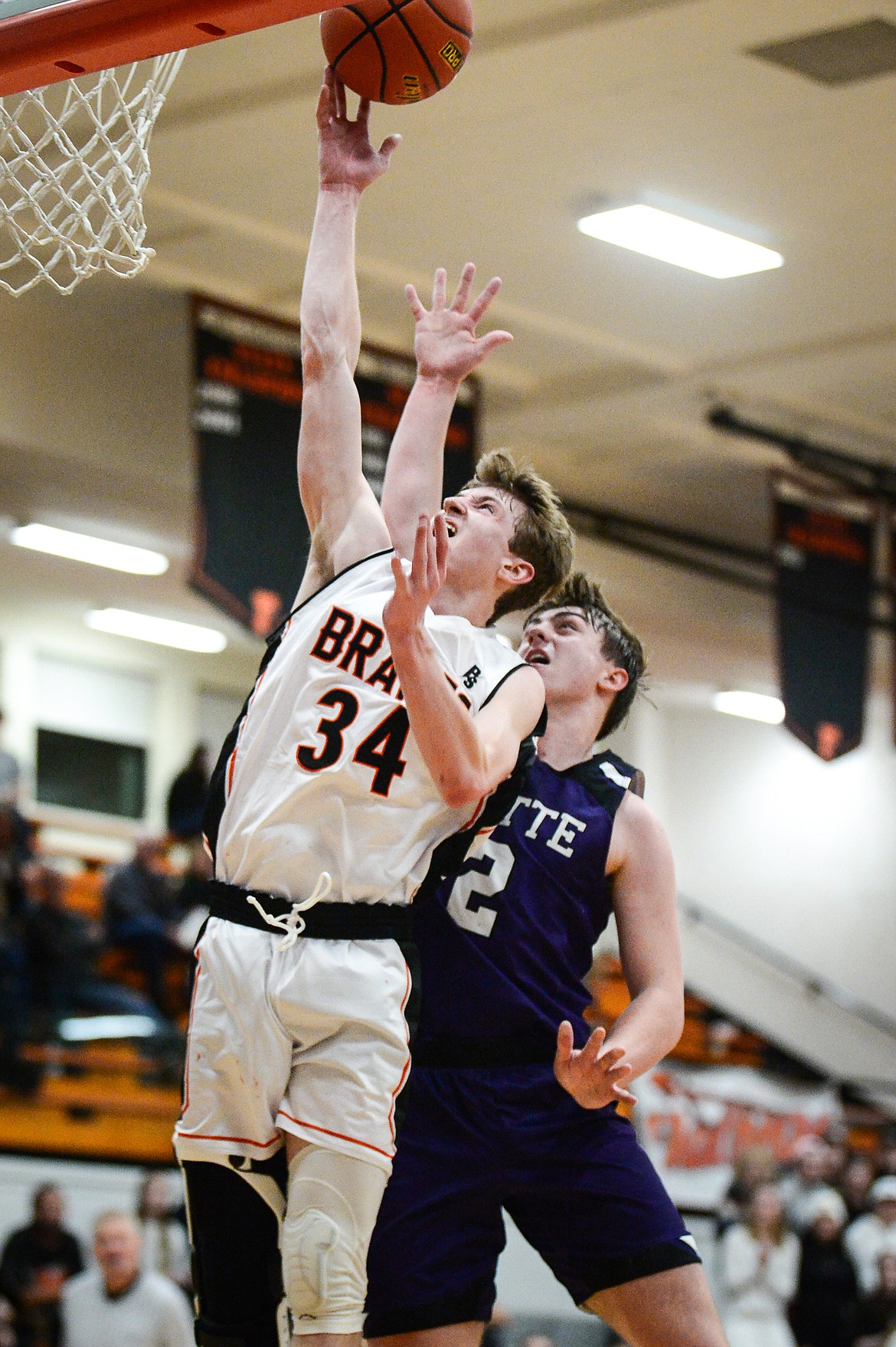 Flathead's Joston Cripe (34) goes to the basket in front of Butte's Jace Stenson (2) at Flathead High School on Friday, Jan. 7. (Casey Kreider/Daily Inter Lake)