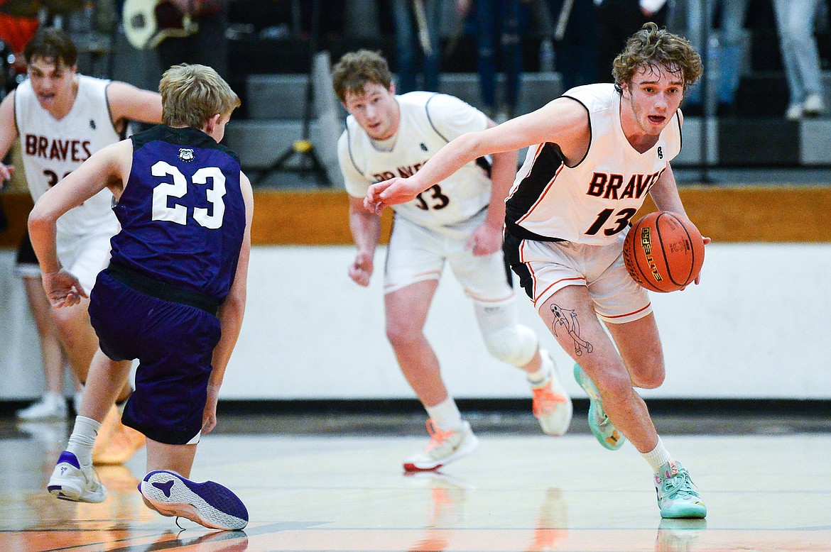 Flathead's Gavin Chouinard (13) steals the ball from Butte's Bo Demarais (23) at Flathead High School on Friday, Jan. 7. (Casey Kreider/Daily Inter Lake)