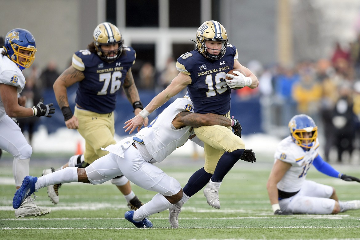 Montana State quarterback Tommy Mellott (16) gets tackled by South Dakota State safety Isaiah Stalbird (2) during the first half of an NCAA college football game in the semifinals of the FCS playoffs, Saturday, Dec. 18, 2021, in Bozeman, Mont. Montana State plays eight-time FCS champion North Dakota State in the national title game Saturday in Frisco, Texas. (AP Photo/Tommy Martino, File)