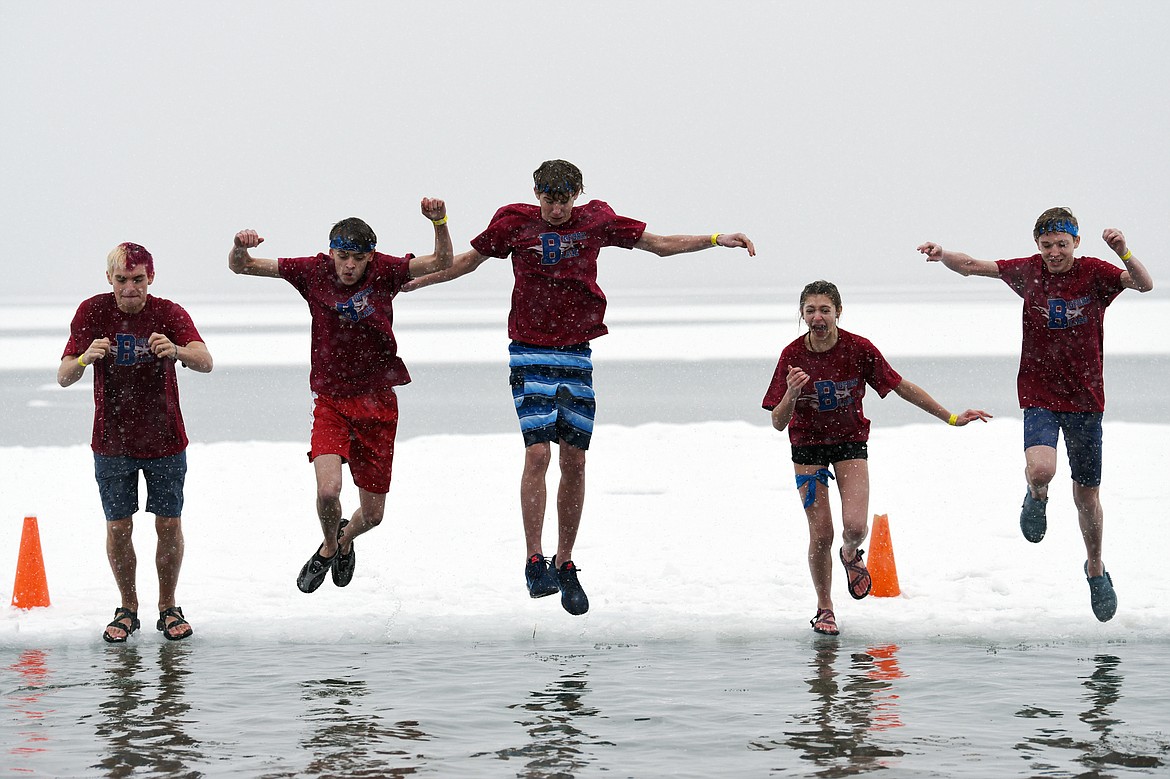 Participants jump into Whitefish Lake at the Whitefish Winter Carnival Penguin Plunge at City Beach on Saturday. (Casey Kreider/Daily Inter Lake file photo)