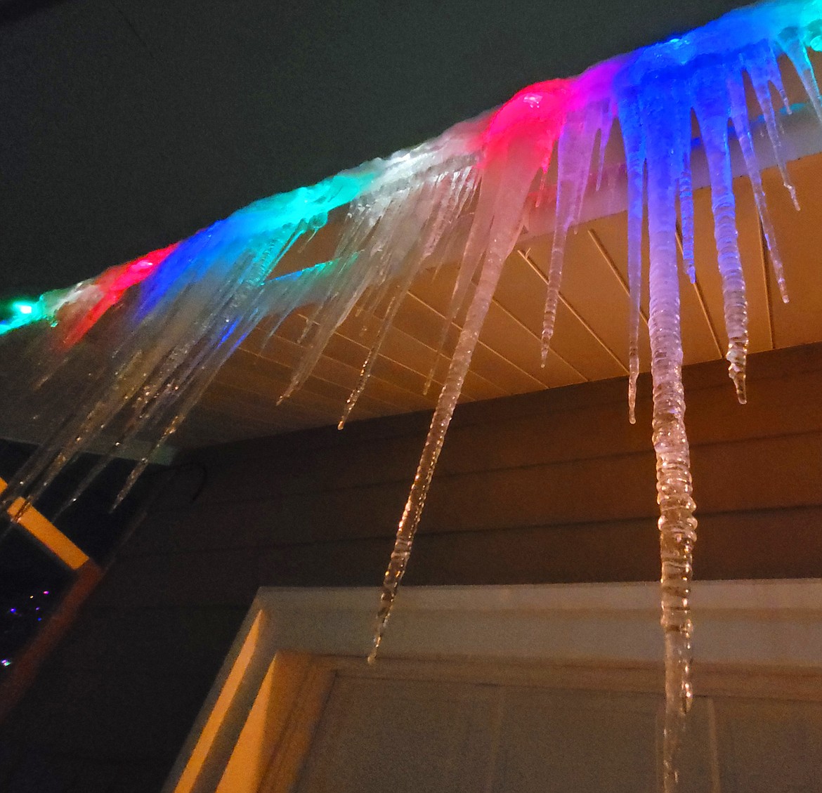 DEVIN WEEKS/Press
Lights glow through long icicles hanging from a roof on 19th Street in Coeur d'Alene on Wednesday night.
