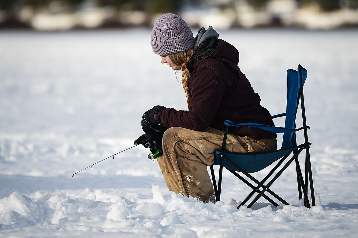 Erin Weaver, from Columbia Falls, waits for a bite at the 51st Sunriser Lions Family Ice Fishing Derby at Smith Lake in Kila on Saturday, Jan. 8. (Casey Kreider/Daily Inter Lake)