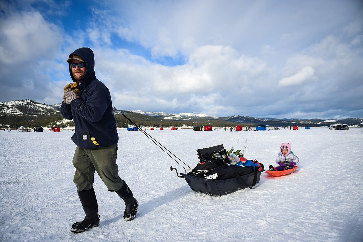 Zach Harms pulls his ice fishing gear and his daughter Madison after a day out on Smith Lake at the 51st Sunriser Lions Family Ice Fishing Derby in Kila on Saturday, Jan. 8. (Casey Kreider/Daily Inter Lake)