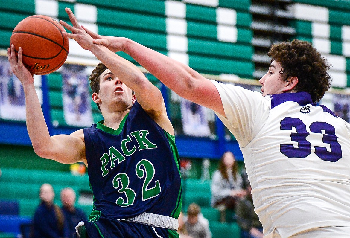 Glacier's Jake Turner (32) gets to the basket with Butte's Kooper Klobucar (33) defending at Glacier High School on Saturday, Jan. 8. (Casey Kreider/Daily Inter Lake)