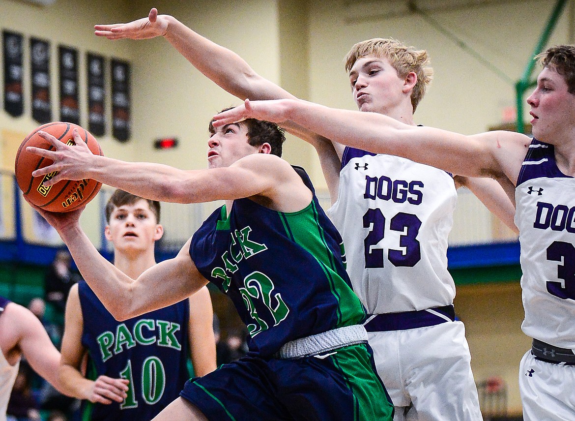 Glacier's Jake Turner (32) drives to the basket past Butte defenders Bo Demarais (23) and Cameron Gurnsey (3) at Glacier High School on Saturday, Jan. 8. (Casey Kreider/Daily Inter Lake)