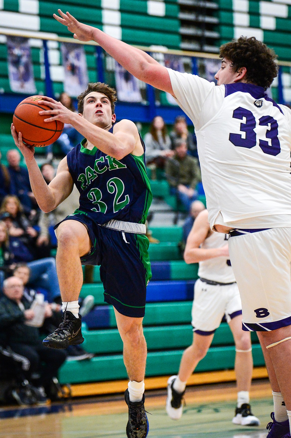 Glacier's Jake Turner (32) gets to the basket with Butte's Kooper Klobucar (33) defending at Glacier High School on Saturday, Jan. 8. (Casey Kreider/Daily Inter Lake)