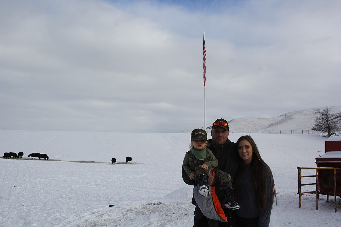 Joe, Menzie and ‘J’ Geldrich stand on their property in the Moiese Valley where they have the tallest flagpole in Montana. (Monte Turner/Mineral Independent)