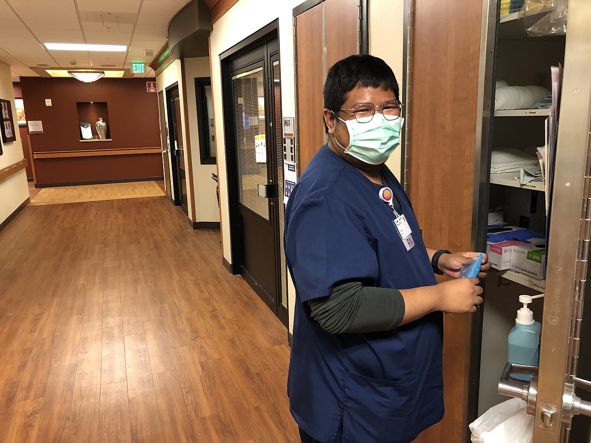 Pae Junthanam, a nurse from Thailand, grabs supplies from a closet inside Billings Clinic in Billings. (Nick Ehli, Kaiser Health News)