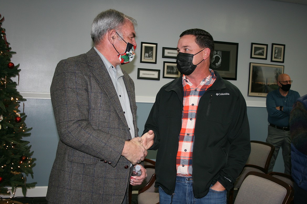 Mark Wanke, left, is congratulated by nephew Jeff Cleveringa for his years on the Ephrata City Council during a reception Dec. 15.