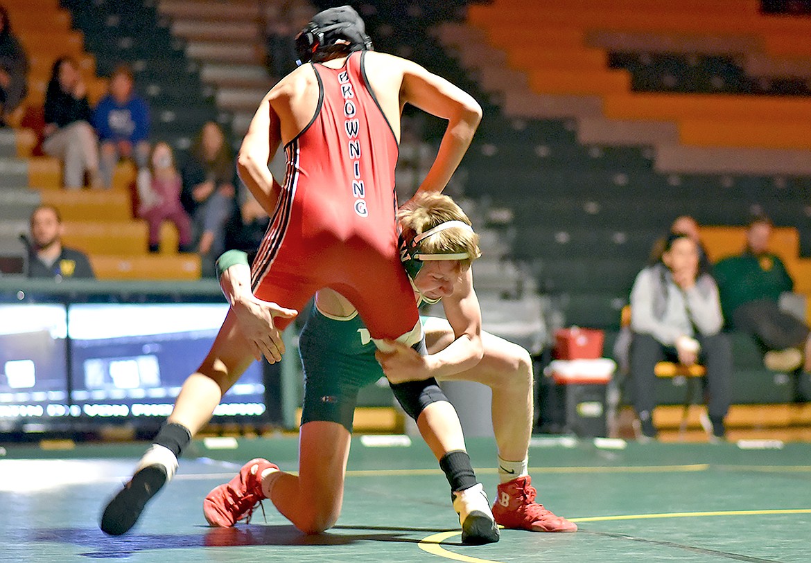 Bulldog freshman Logan Heyne works to take down Browning’s Sno Momberg in a wrestling dual at WHS on Thursday. (Whitney England/Whitefish Pilot)
