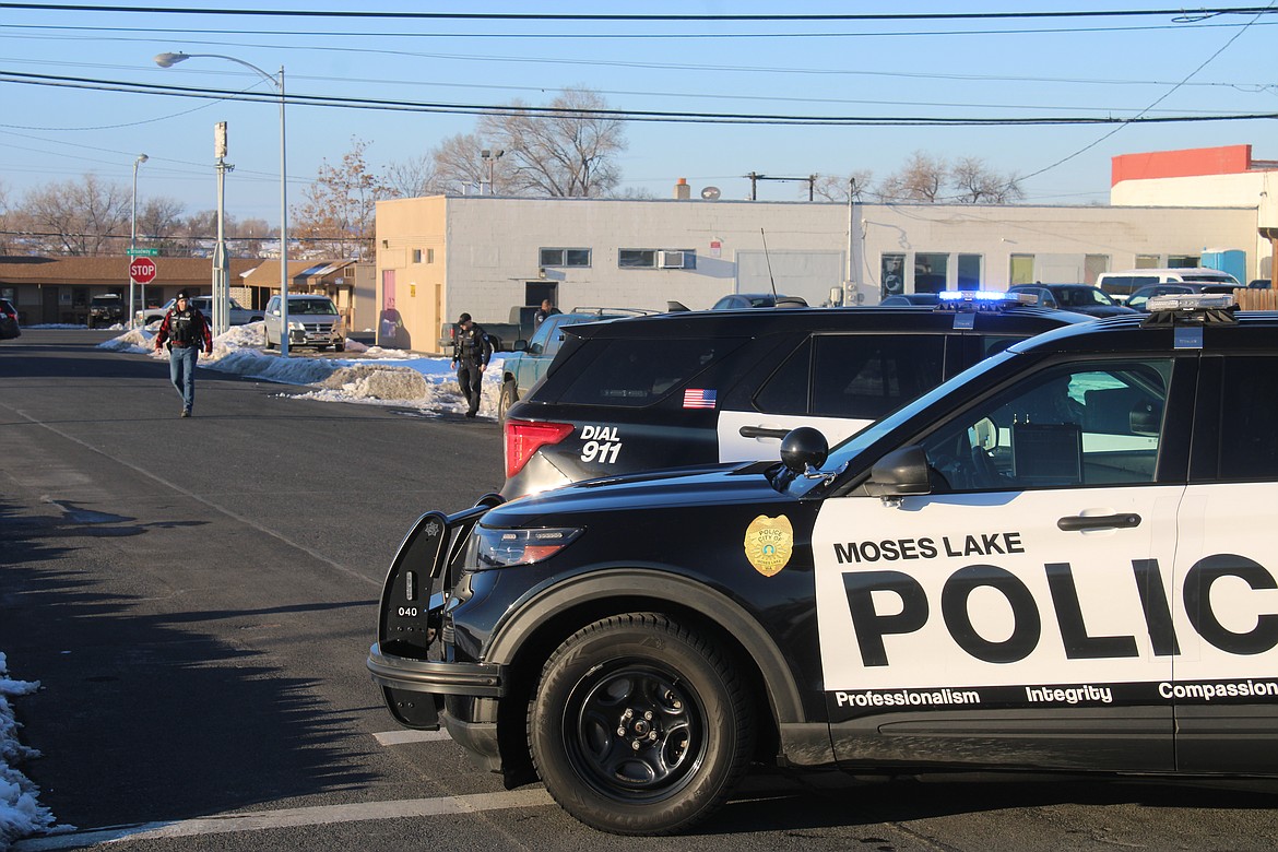 Moses Lake Police Department officers look for shell casings after an alleged drive-by shooting Monday afternoon on Gumwood Street.