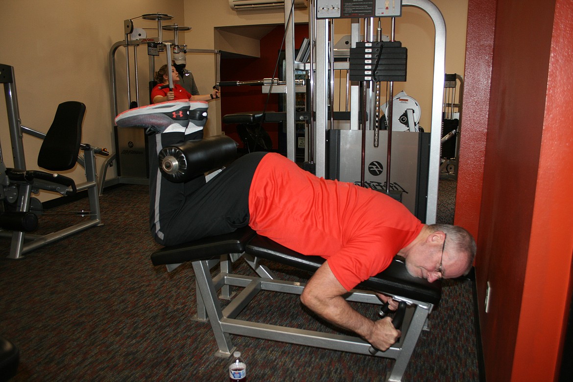 Dennis Gerber does leg exercises Friday morning at the South Campus Athletic Club in Moses Lake.