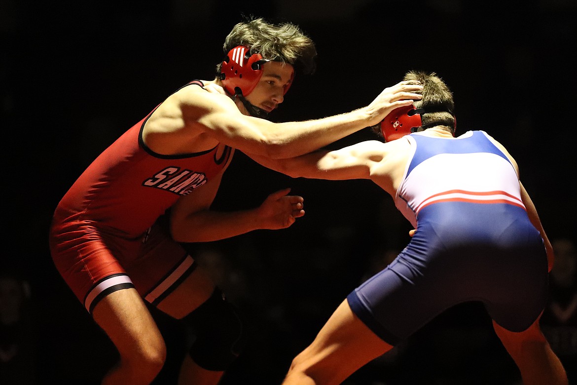 Adam Belgarde fends off his opponent during Wednesday's dual.