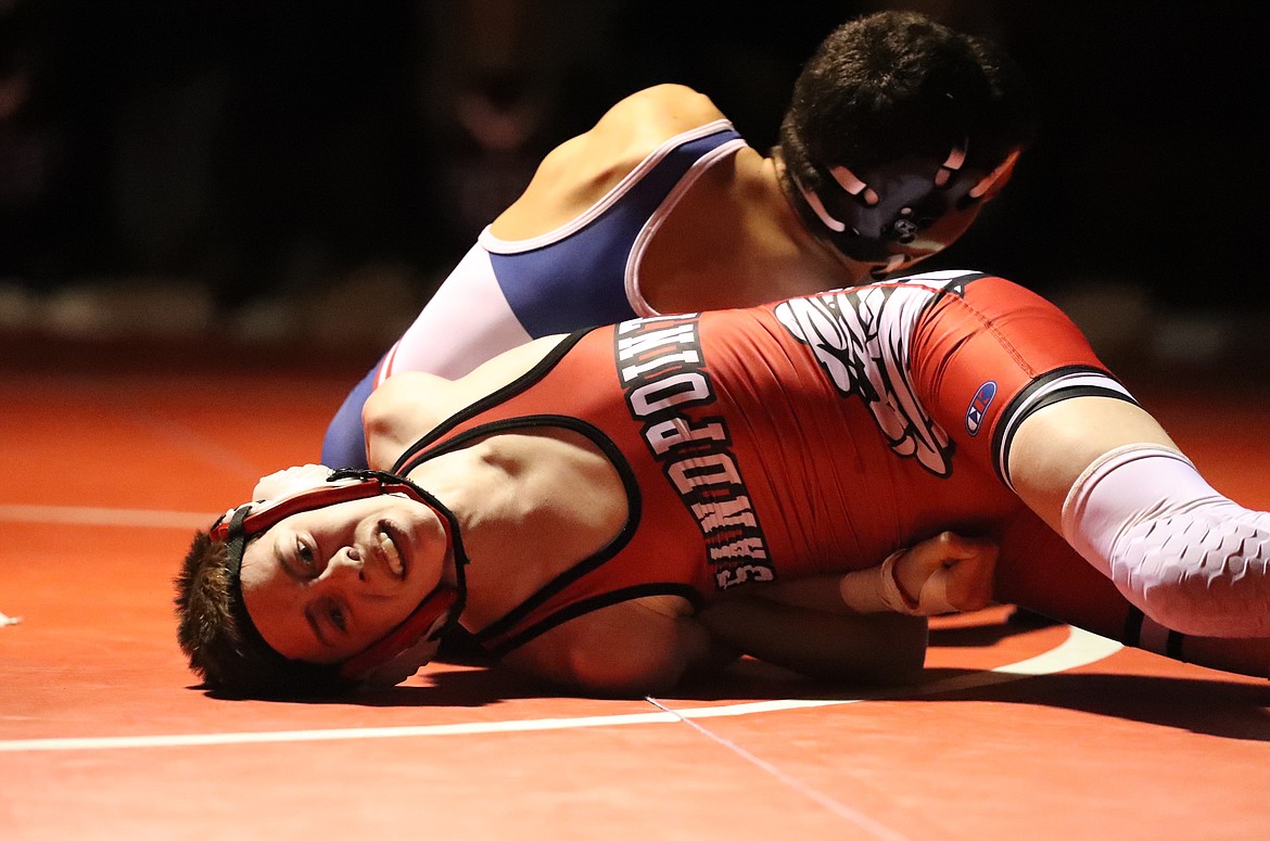 Andrew Duke tries to avoid getting pinned Wednesday.