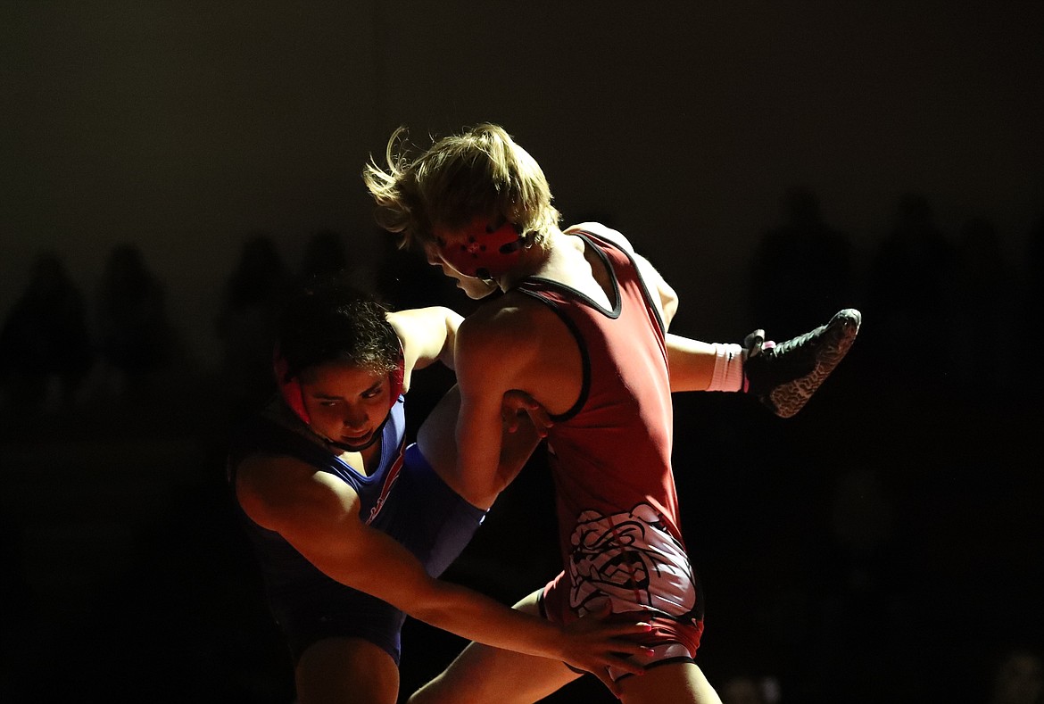 Forest Ambridge (right) takes down Alyssa Randles during their match Wednesday.
