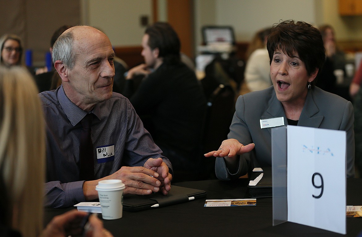 Nadeen Hayes of U.S. Bank and Bill Muck of Onsite for Seniors participate in a speed round of introductions and "elevator pitches" during the North Idaho Alliance's Perk It Up '22 event Wednesday morning in the Kroc Center.