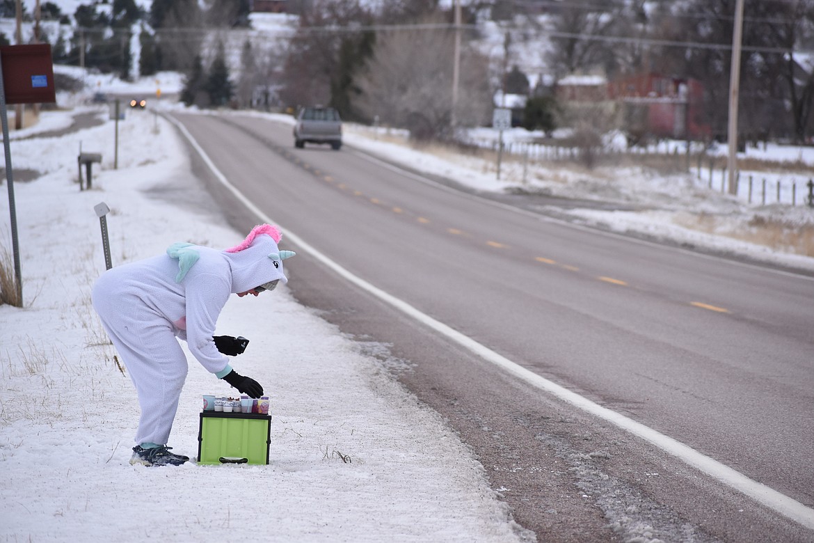 A costumed volunteer offers refreshments at one of the aid stations. (Emily Lonnevik/Lake County Leader)