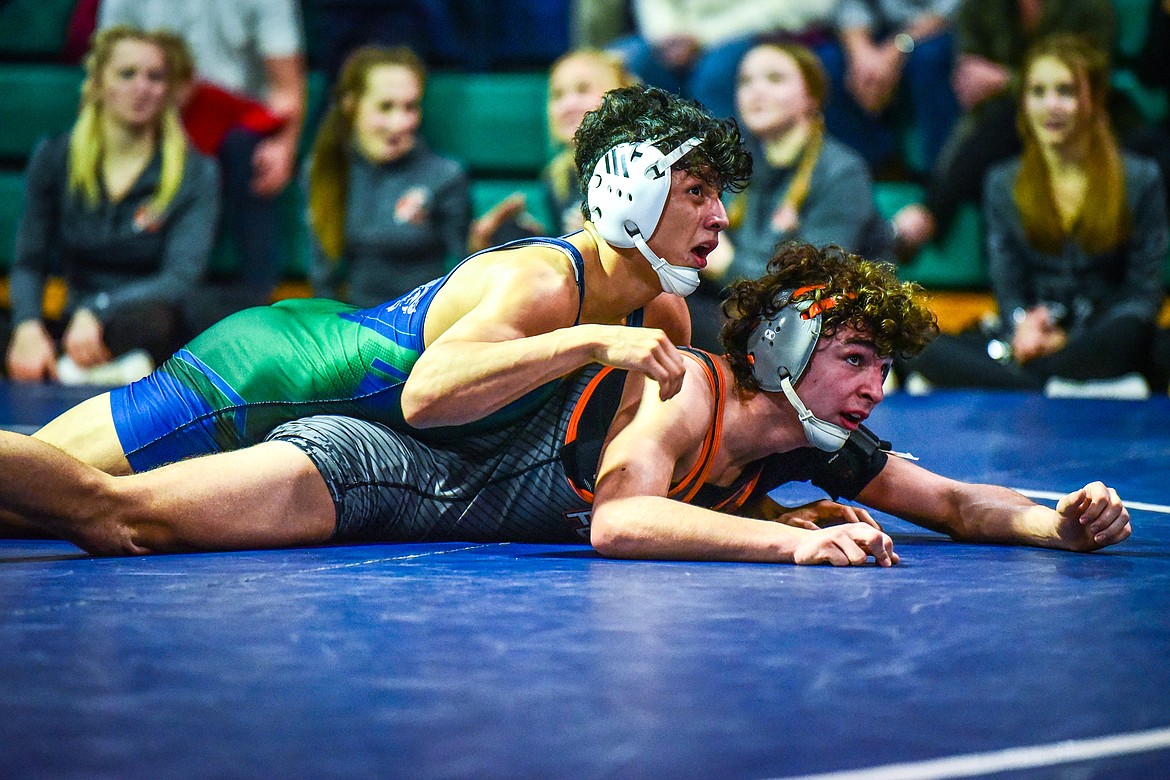 Glacier's Teegan Vazquez and Flathead's Asher Kemppainen look to the clock as time expires in the third period of their match at 132 pounds at Glacier High School on Thursday, Jan. 13. (Casey Kreider/Daily Inter Lake)