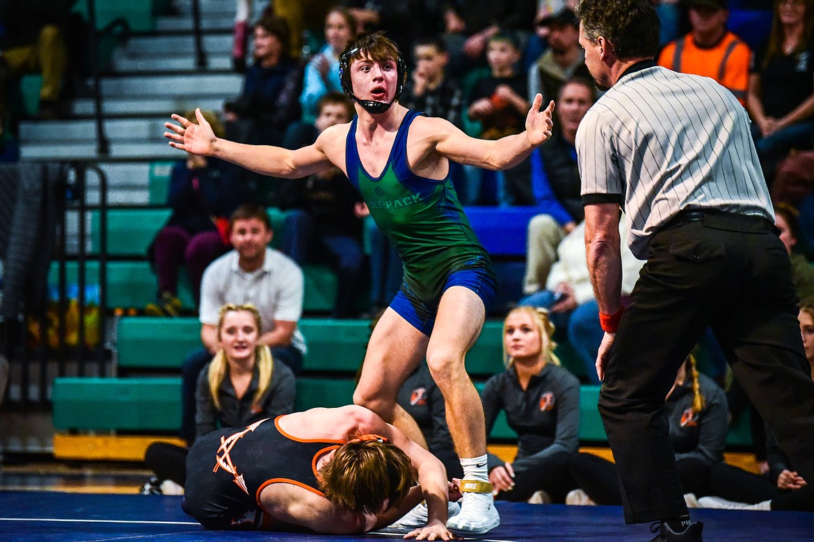 Glacier's Kaleb Shine celebrates after a pin of Flathead's Cade Gardner at 138 pounds at Glacier High School on Thursday, Jan. 13. (Casey Kreider/Daily Inter Lake)