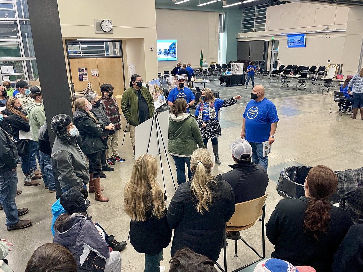 Vanguard Academy Planning Principal Kelly Cutter (center, pointing), along with academy teacher Amador Castro, welcome parents and prospective Vanguard Academy students at the Columbia Basin Technical Skills Center Wednesday.