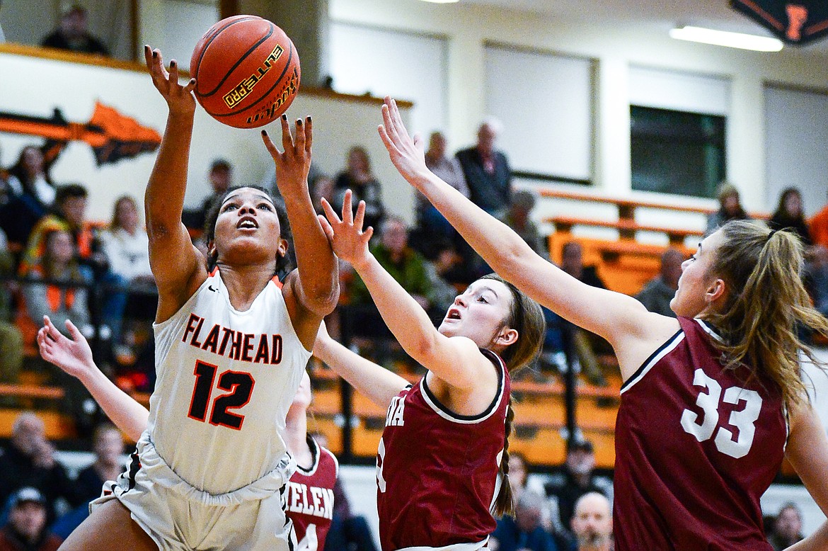 Flathead's Akilah Kubi (12) draws contact on her way to the basket against Helena High at Flathead High School on Friday, Jan. 14. (Casey Kreider/Daily Inter Lake)