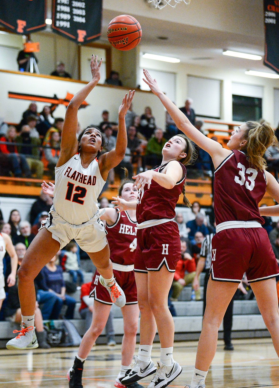 Flathead's Akilah Kubi (12) draws contact on her way to the basket against Helena High at Flathead High School on Friday, Jan. 14. (Casey Kreider/Daily Inter Lake)