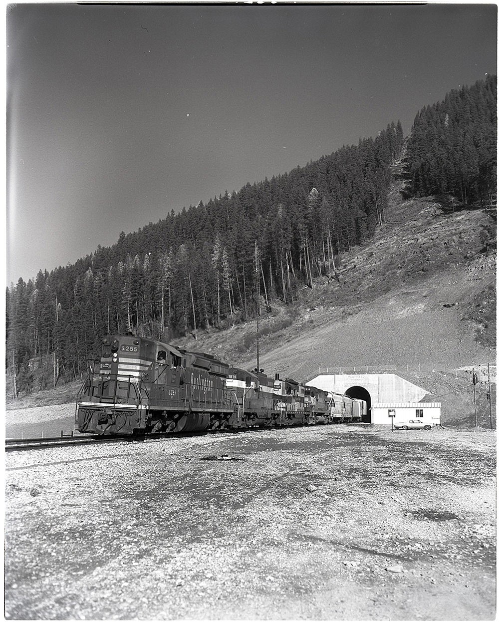 A train emerges from the south portal of the Flathead Tunnel. (Mansfield Library, University of Montana)