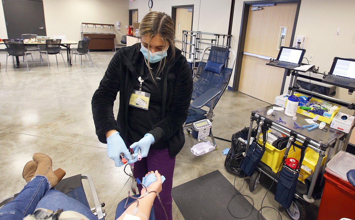 Hannah Martinez, donor care specialist, prepares to draw blood from Tolli Willhite on Friday at Kootenai Health.