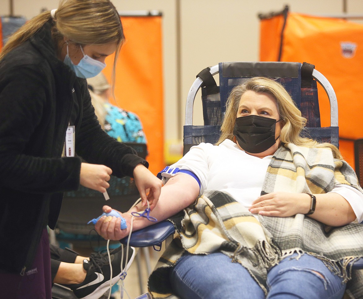 Hannah Martinez, donor care specialist, prepares to draw blood from Tolli Willhite on Friday at Kootenai Health.