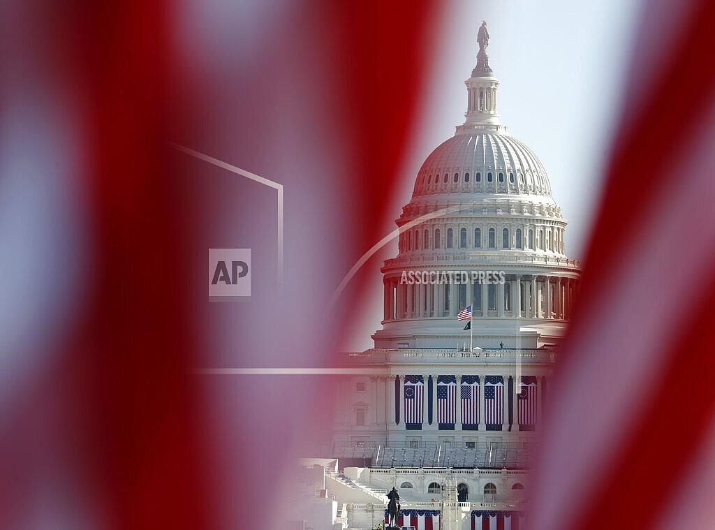 The U.S. Capitol is seen through a display of flags on the National Mall, one day after the inauguration of President Joe Biden, on Jan. 21, 2021, in Washington. Just over a year ago, millions of energized young people, women, voters of color and independents joined forces to send Joe Biden to the White House. But 12 months after he entered the Oval Office, many describe a coalition in crisis. (AP Photo/Rebecca Blackwell, File)