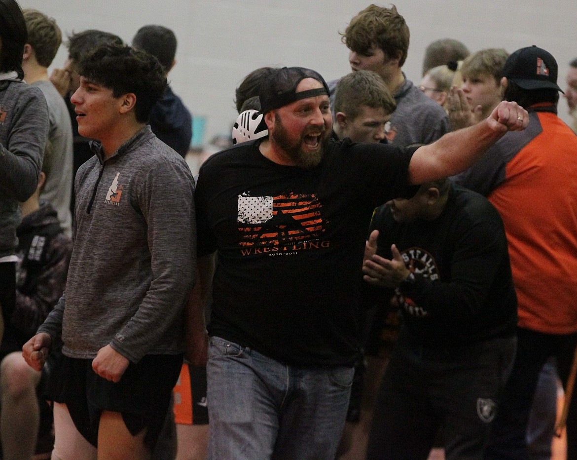 JASON ELLIOTT/Press
Post Falls wrestling coach Pete Reardon celebrates a pin with his fans during Saturday's third-place dual against Meridian in the River City Duals at Post Falls High.