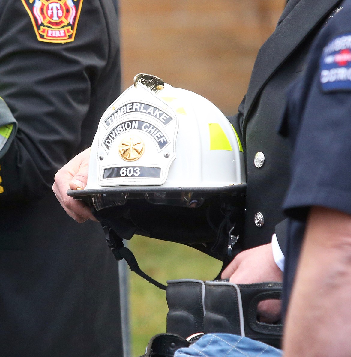William "Bill" Wright's fire gear is carried out during the final procession at his memorial service at North Idaho College on Saturday.