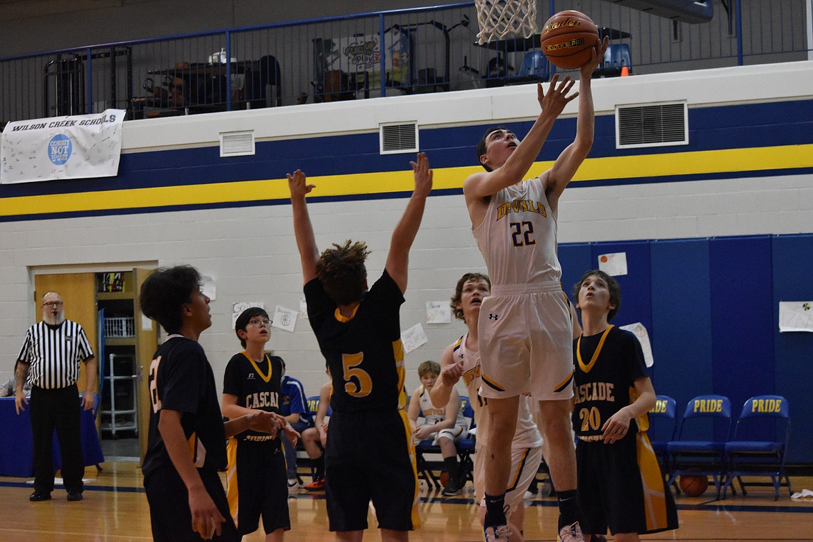 Wilson Creek High School senior Kass Newman (22) goes in for a shot and draws a crowd of Cascade Christian Academy defenders Wednesday.