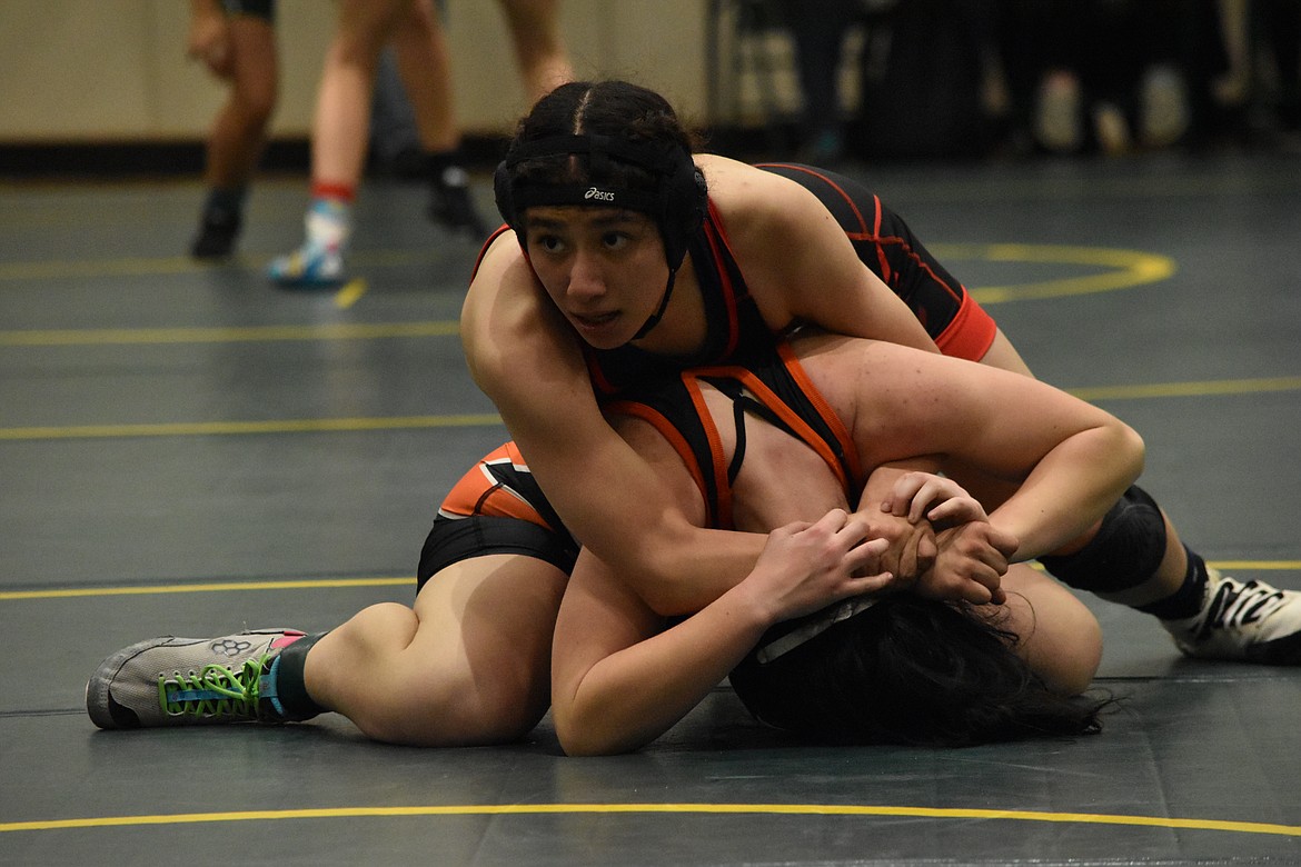 An Othello High School wrestler works to pin a Cashmere High School opponent during the Quincy Bring Home Da Beef tournament on Saturday.