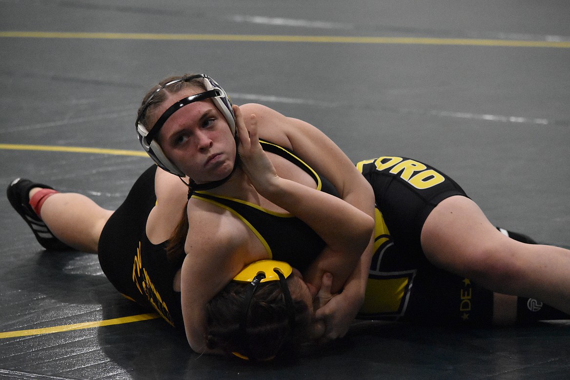 A Hanford High School wrestler puts a Moses Lake High School opponent in a headlock during the Quincy tournament on Jan. 15.