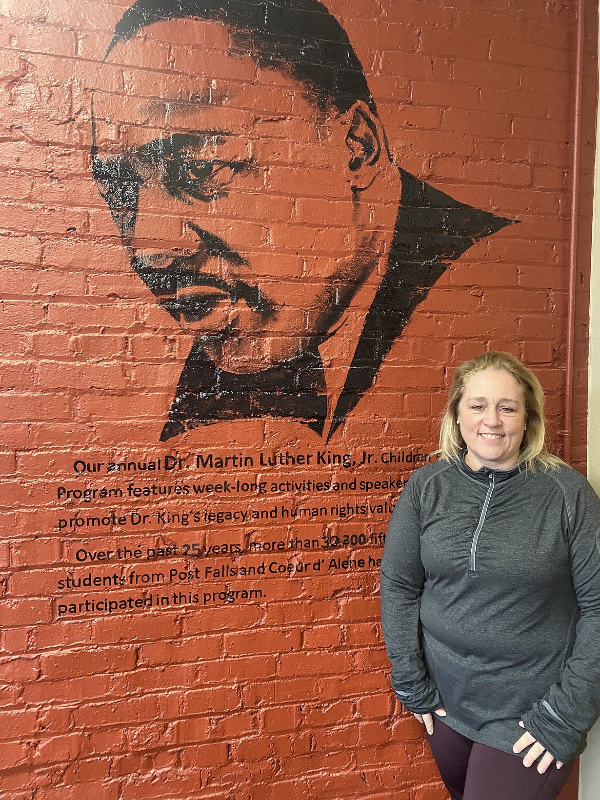 Human Rights Education Institute, Executive Director Jeanette Laster stands in front of a mural Monday, of Martin Luther King Jr. in the lobby of the center following a presentation for MLK Day. Celebrating diversity and human rights is the focus, rather than focusing only on the human struggle, Laster said.