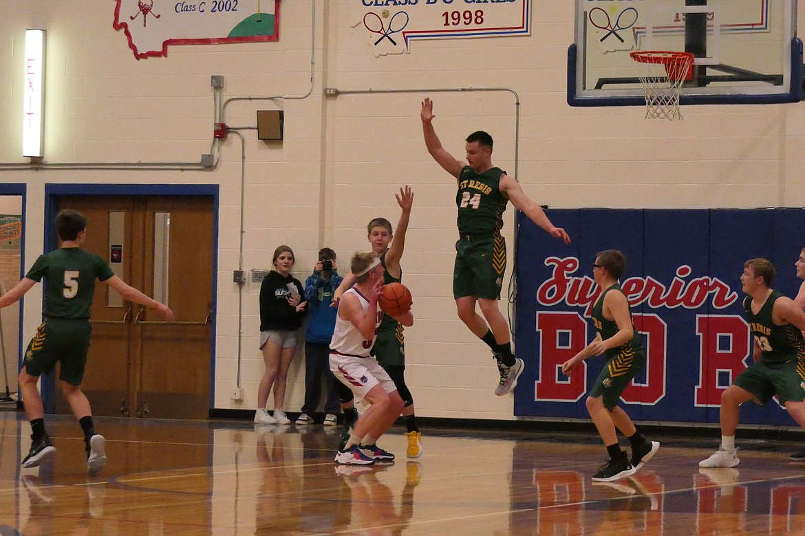 St. Regis forward Adam Ball goes airborne to block a shot by Superior's Owen Doyle during last week's game in Superior.   (Chuck Bandel/Valley Press)