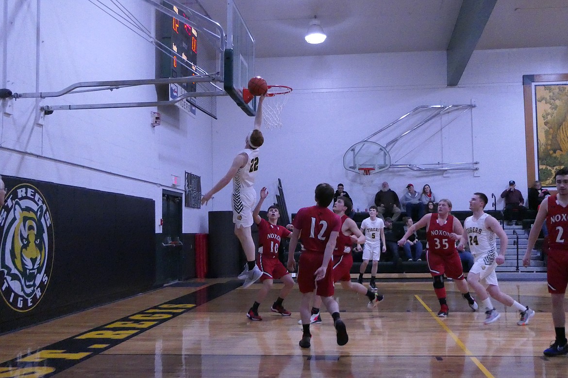 Tanner Day goes up for two points during the Tigers' win over Noxon Friday evening in St. Regis.   (Chuck Bandel/Valley Press)