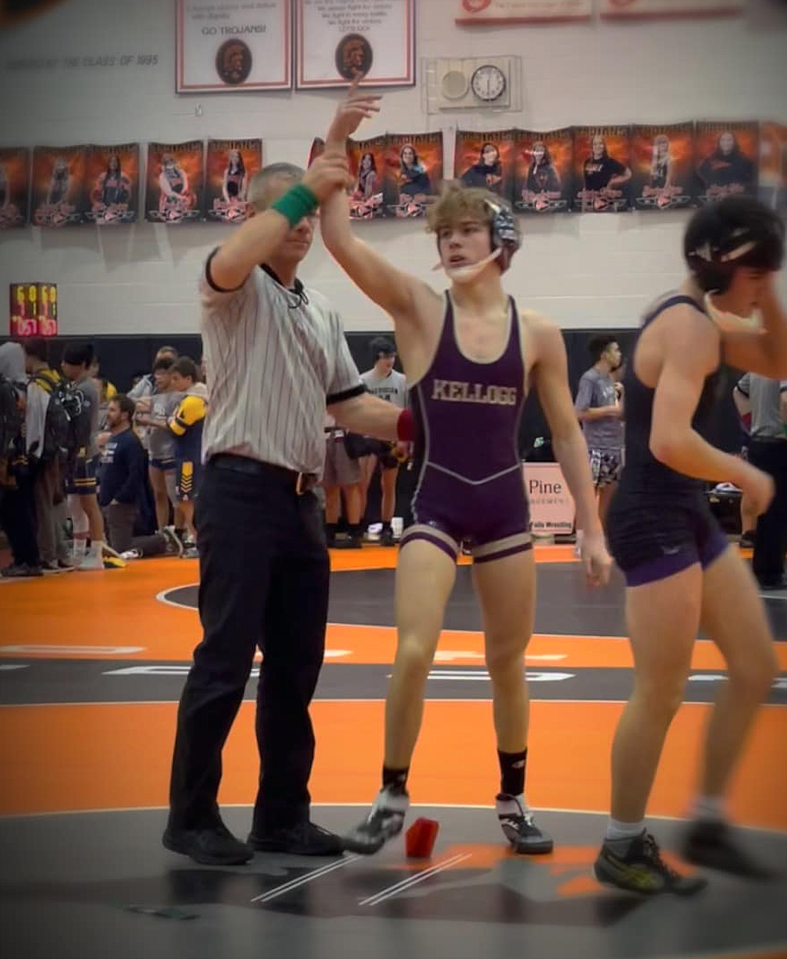 Kellogg's Kolter Wood has his hand raised in victory following a match at the River City Duals.
